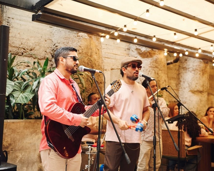 A group of musicians performing live music in a lively restaurant setting, entertaining diners with their performance